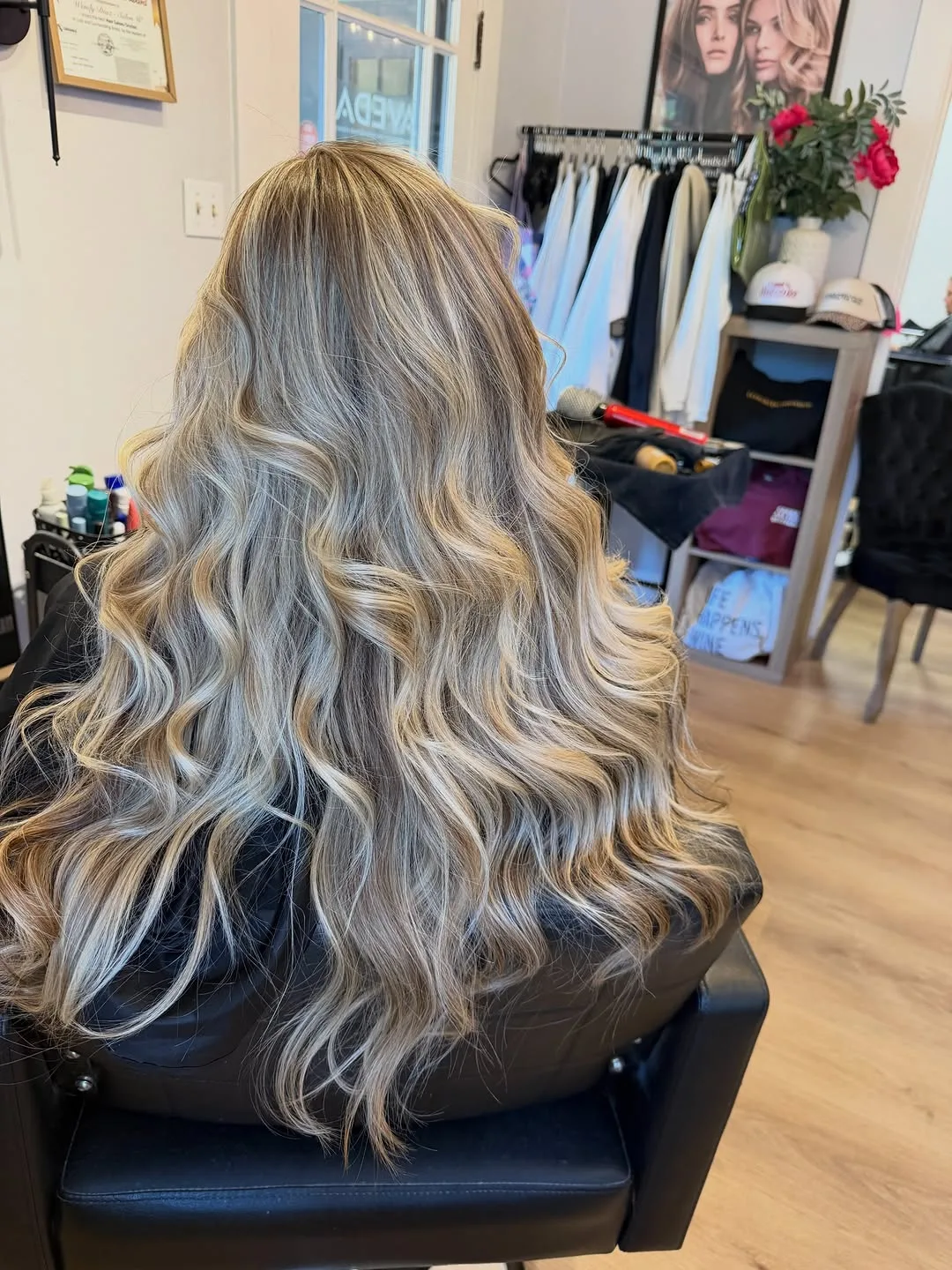 Long blonde balayage with a shadowed root and voluminous waves, photographed from behind at Salon W
